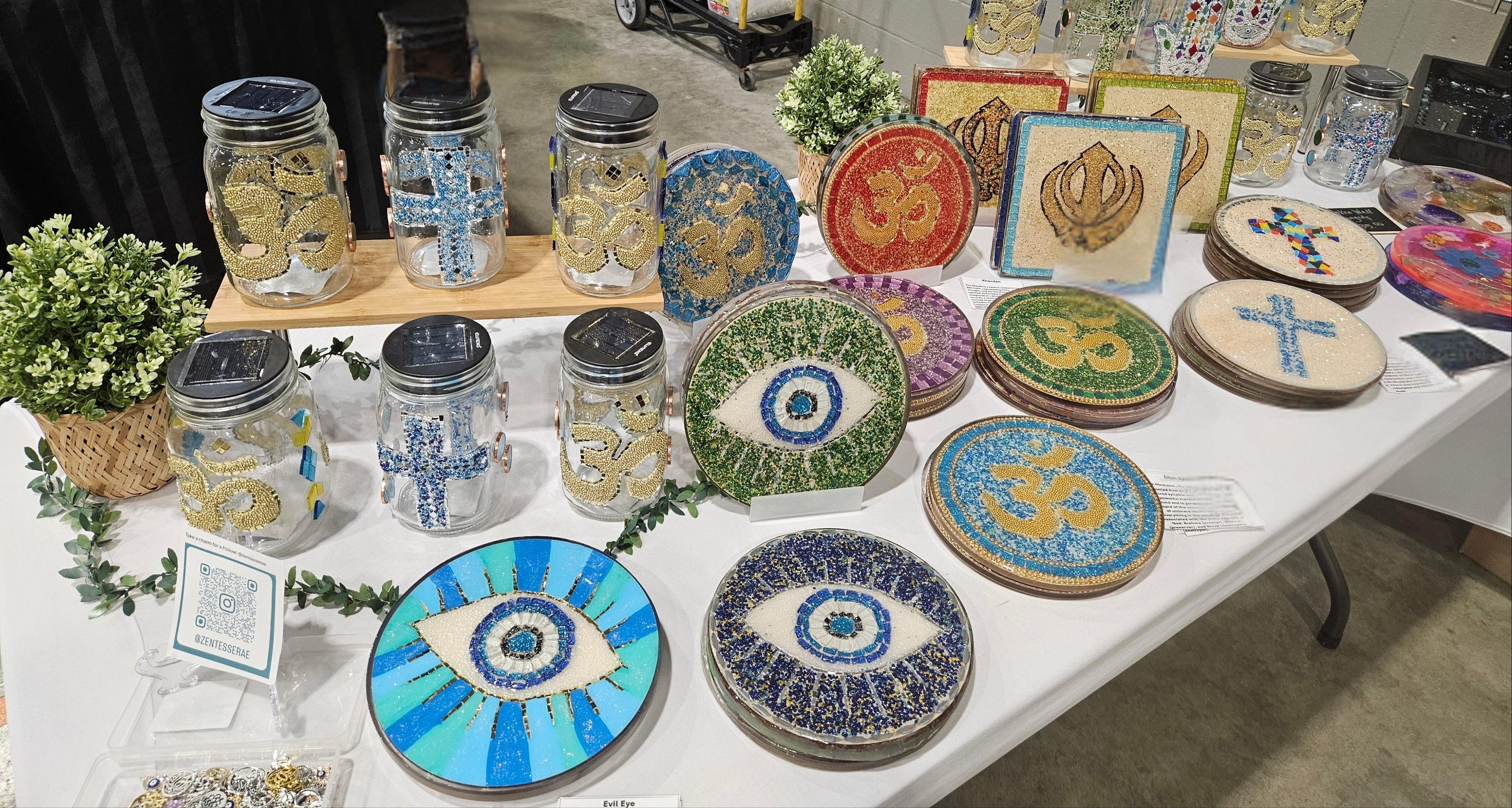 Table displaying various decorative items including jars and plates with artistic designs.